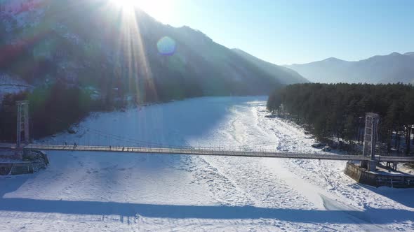 Aerial Footage of Hanging Bridge Over Frozen Katun River at Altai Republic