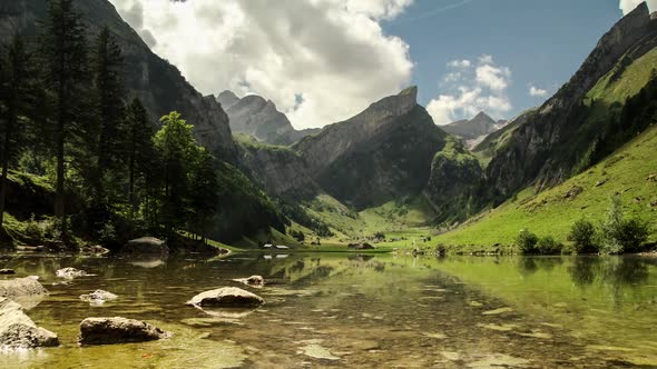 Timelapse Clouds Float over Lake Seealpsee in Swiss Alps