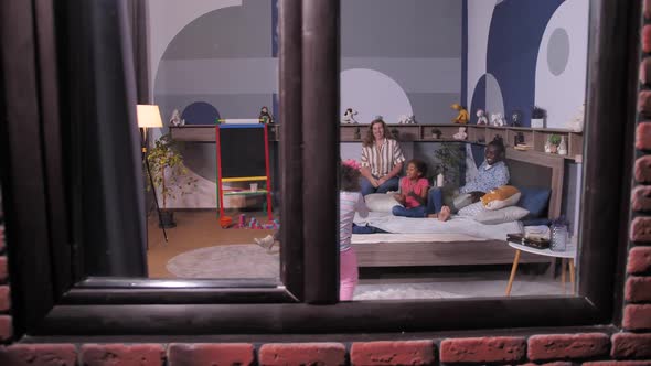 Joyful Children Playing Ball with Parents at Home alt