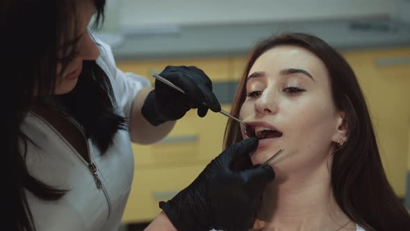 Young Pretty Girl Sits in Dental Cabinet on Treatment and Consultating alt