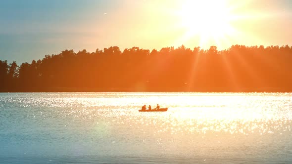 Fishermen In The Boat On The Sunset