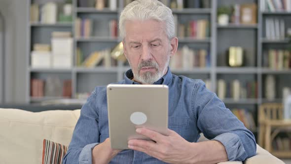 Old Man Using Tablet alt