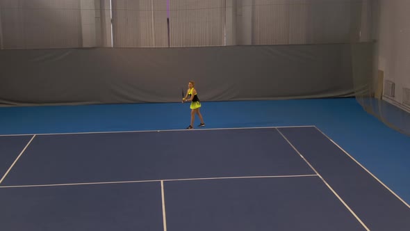 Wide Shot of Beautiful Young Sportswoman Serving Ball in Big Tennis Game. Confident Concentrated alt