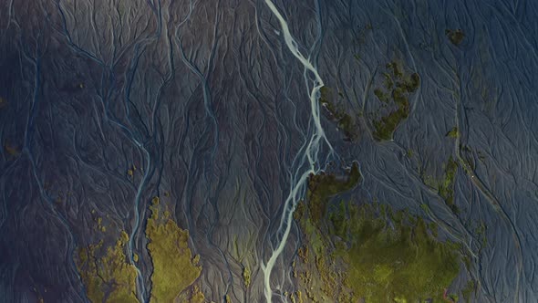 Drone Over Sunlit Landscape With Dry Riverbed Of Braided River alt