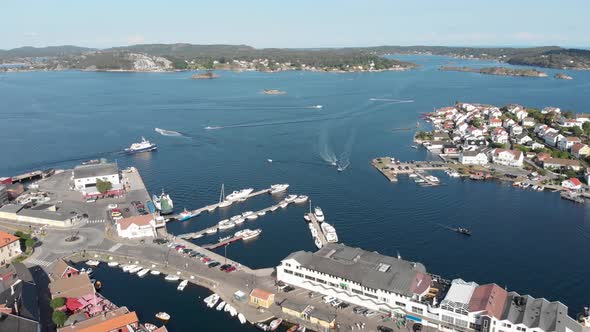 Drone view - boating traffic and local ferry at marina of Kragero, Norway alt