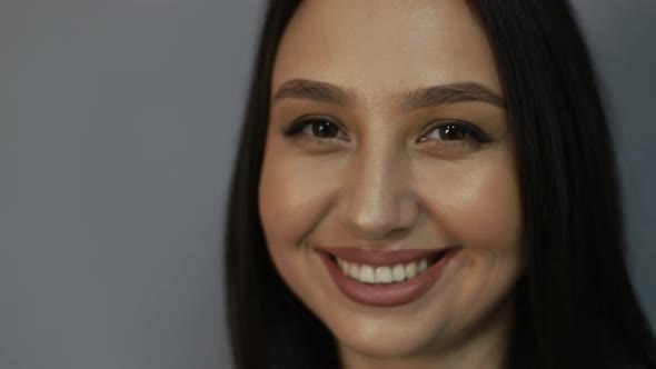 Brunette woman looking at camera alt