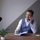 Handsome Male Office Manager Using Smartphone at Workplace Sitting on a Desk - VideoHive Item for Sale