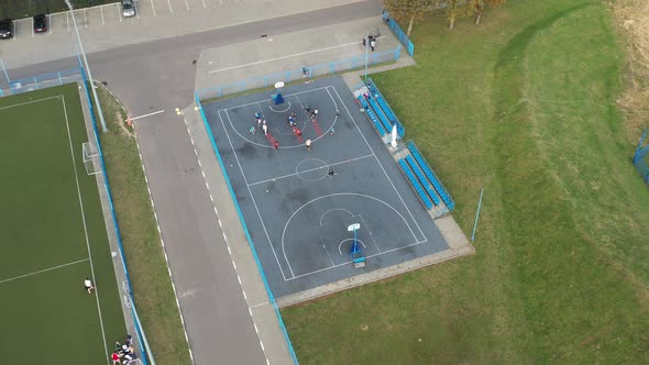 Top View of the Basketball Court on the Street and the Basketball Players Training with the Ball