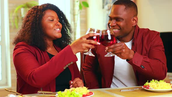 Handsome Elegant Man and His Girlfriend Drink Red Wine While They Having a Romantic Date in Living alt