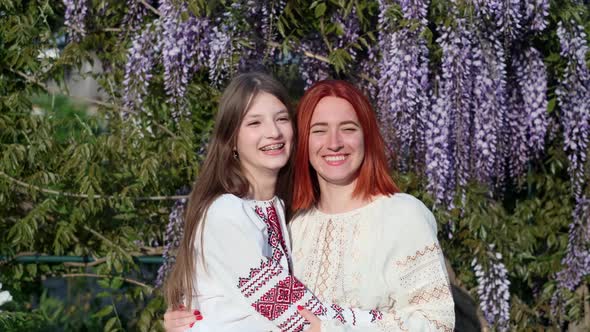Girlfriends in National Traditional Clothes Vyshyvanka Hug and Smile in Nature alt
