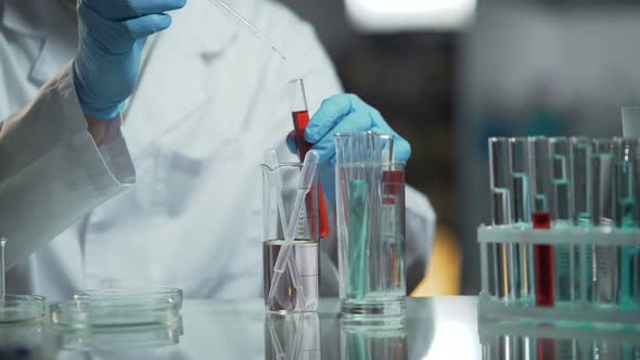 Medical Analyst Doing Biochemical Research of Blood Samples at His Laboratory alt