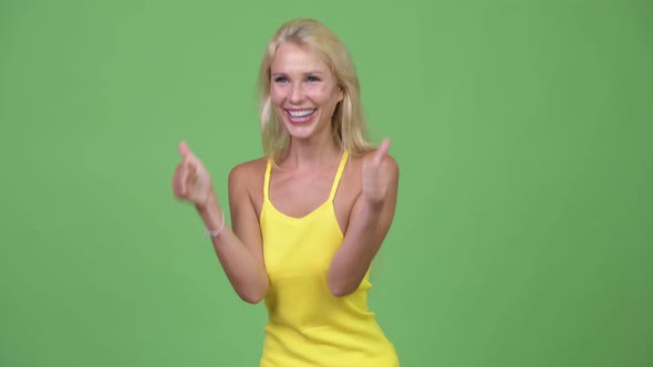 Young Happy Beautiful Blonde Woman Giving Thumbs Up While Looking Excited