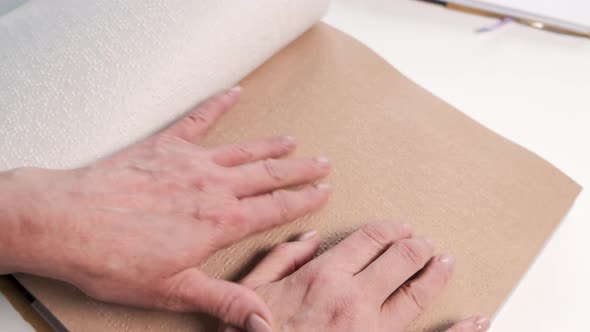 Blind Mature Woman Reading Braille Book at Home alt