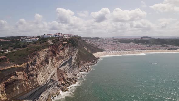 Aerial panoramic view Nazaré coastline, village and endless sandy beach - Portugal alt