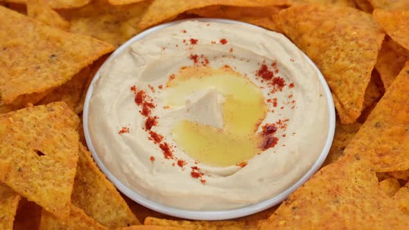Snack hummus with smoked paprika and tortilla chips rotate alt