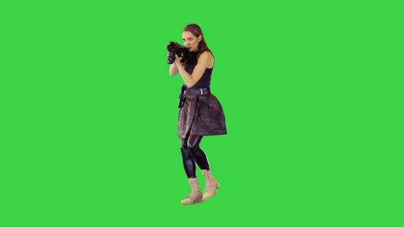 Cyberpunk Girl Walks with Machine Gun Taking an Aim Making a Single Shot on a Green Screen Chroma