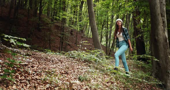 Woman with Backpack Hiking in Forest