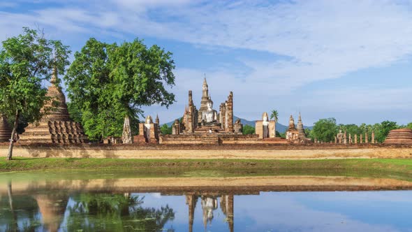 Buddha statue and Pagoda at Wat Mahathat temple, Sukhothai Historical Park, Thailand - Time Lapse