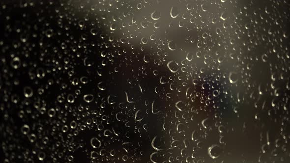 Raindrops On Glass At Night
