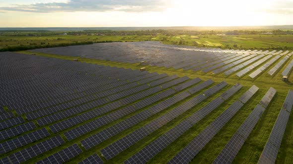 Aerial View of Big Sustainable Electric Power Plant with Rows of Solar Photovoltaic Panels for Clean alt