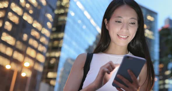 Woman using mobile phone at night  alt