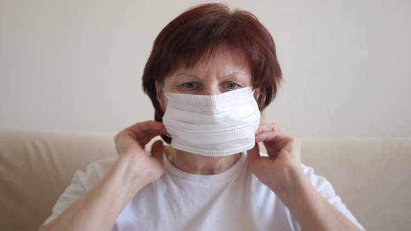 Woman Putting on Surgical Mask for Corona Virus Prevention.