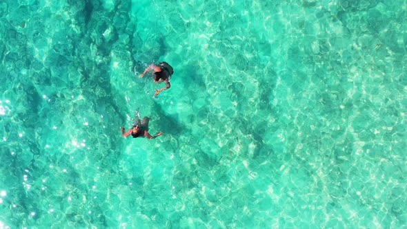 Two people snorkel in clear Caribbean water. two girls having fun on tropical vacation alt