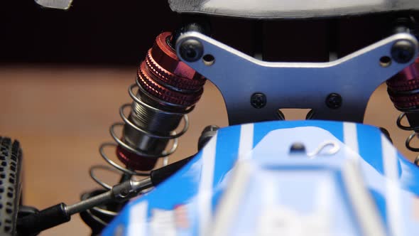 Closeup of Radio Control Model Suspension Elements Buggy Car on Cutting Mat