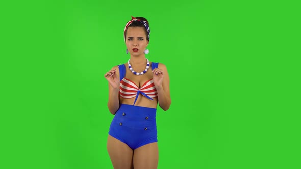 Beautiful Girl in a Swimsuit Is Making Herself Manicure with Pink Nail File. Green Screen alt