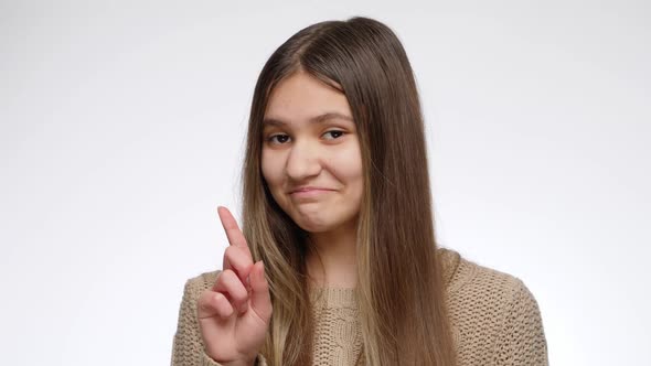Portrait of Smiling Teenage Girl Shaking Her Head and Showing No Gesture with Index Finger alt