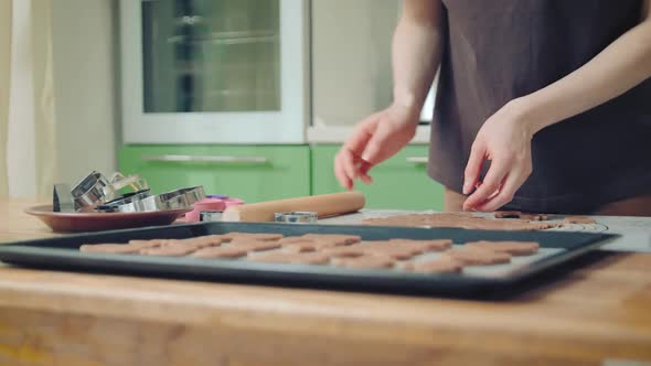 Young Woman in Brown Tshirt Baking Cookies on a Silicon Mat at Home Kitchen