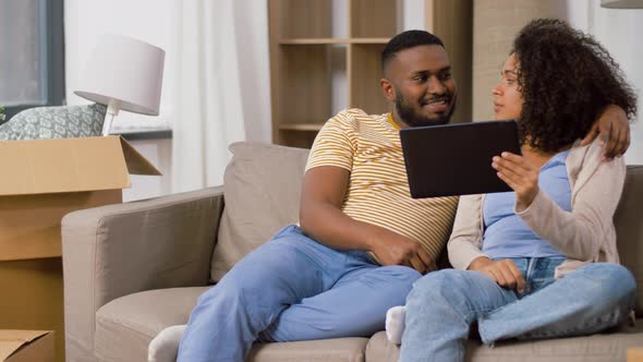 Happy Couple with Tablet Pc Computer at New Home alt