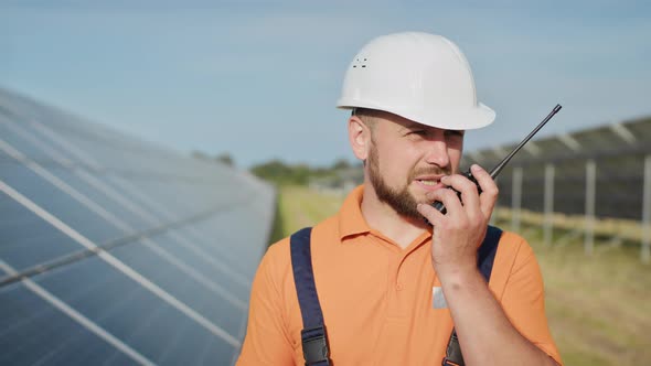 Happy Caucasian Adult Engineer in Helmet Smiling at Camera at Solar Power alt