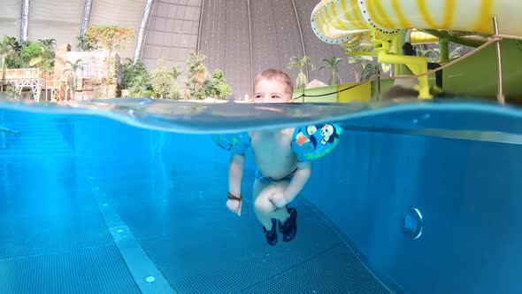 Little boy swimming in the pool. Water, underwater, indoors. Happy child.
