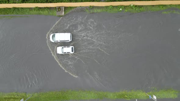 Aerial View of City Traffic with Cars Driving on Flooded Street After Heavy Rain alt