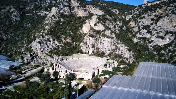 High angle drone aerial view of ancient greek rock cut lykian empire amphitheatre and tombs in Myra alt
