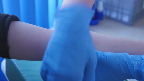 Doctor Bandages Patient's Hand After Close-up Shot