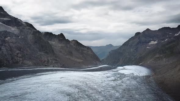 travelling above a glacier in the swiss alps range in Europe with the Grindelwald valley in the back alt