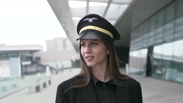 Young Attractive Woman Captain Officer Working for Airline at Terminal alt