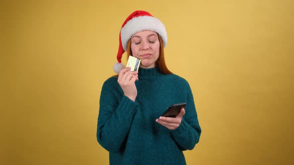 Dreamful Cute Woman in Santa Christmas Hat Hold Credit Bank