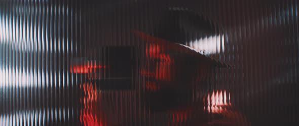 Shape of a man thorugh shaped clear panel in red lights alt