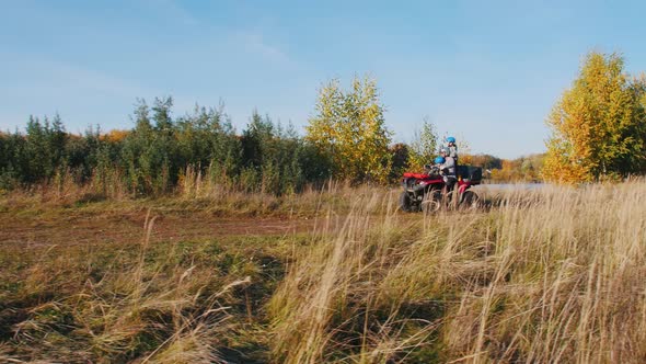 Outdoor Activity - People Riding ATVs on the Autumn Field and Stopping at an Edge Cliff alt