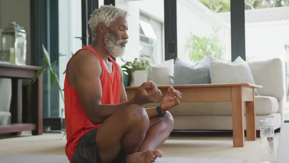 Video of african american senior man meditating alt