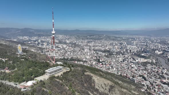 Aerial view of TV Tower in Mtatsminda park. Against the background of the city. Tbilisi, Georgia alt