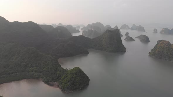 Aerial: unique flying over Ha Long Bay and Cat Ba island at sunset Vietnam alt