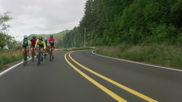 Tracking shot of a group of cyclists on country road.  Fully released for commercial use.