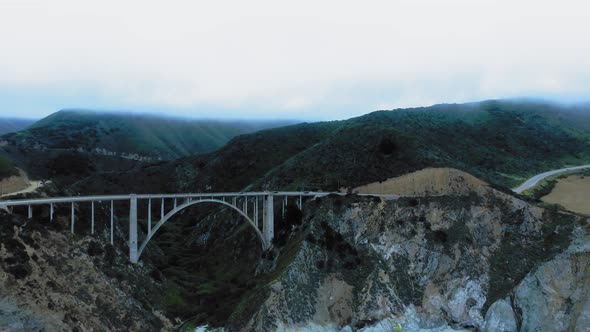 Aerial panorama of Bixby Creek Bridge between the green rocks at Big Sur, California, USA alt