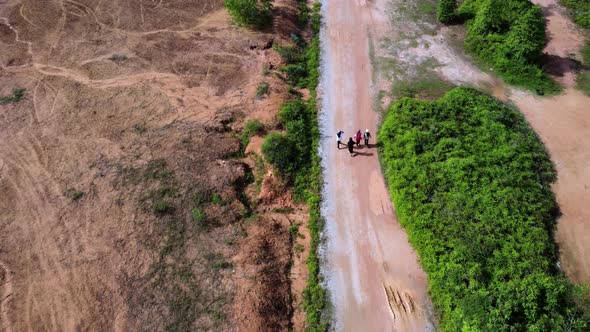 Aerial top down view Muslim girl walk at the rural path alt