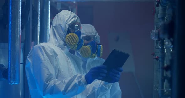 Scientists in Hazmat Suit Conducting Maintenance alt