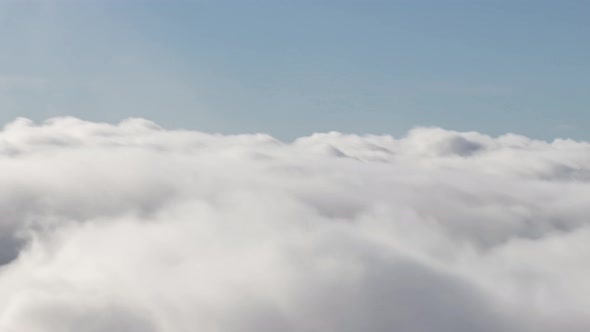 Aerial Timlapse of White Puff Clouds During a Sunny Day alt